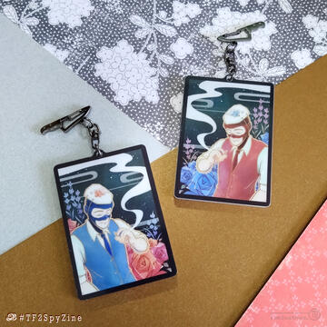 Photo by TB (tangentburd) for a double-sided hanafuda-themed acrylic charm for the TF2 Spy zine "Intruder Alert". On either side, RED/BLU Spy is in a rose garden, smiling with his eyes closed.