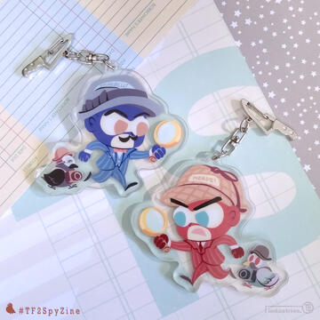 Photo by TB (tangentburd) for a double-sided detective acrylic charm for the TF2 Spy zine "Intruder Alert". One side has RED Spy as Sherlock Holmes with a pigeon in disguise; the other side has BLU Spy as Hercule Poirot with a crow in disguise.